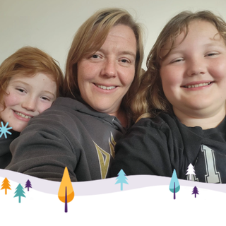 A photo from our Christmas appeal, featuring Joanna and her daughters with a festive border featuring a snowy scene and fir trees underneath.